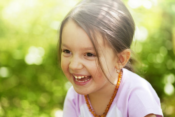 Beautiful little girl smiling outdoors