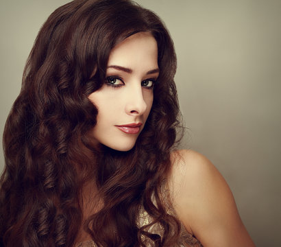 Fashion luxury female model with long curly hair