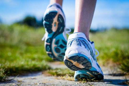 close up details of feet running shoes in action outdoor