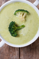 Cream soup of broccoli macro vertical. top view