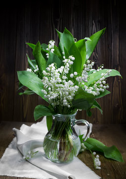Lilies of the valley in a  pitcher.