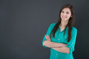 Portrait of a young happy woman isolated on a blackboard.