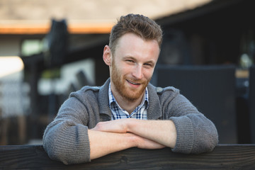 Fototapeta premium Portrait of handsome young man smiling outdoors