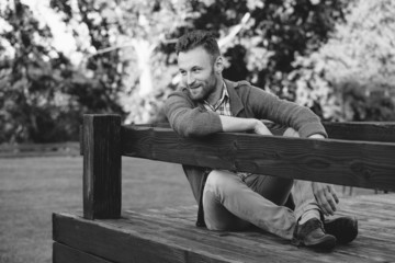 Portrait of handsome young man smiling outdoors