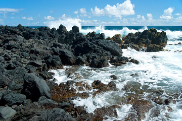 Fototapeta na wymiar Volcano rocks on beach at Hana on Maui Hawaii