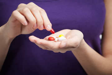Woman takes antibiotics, isolated on white. Taking medication