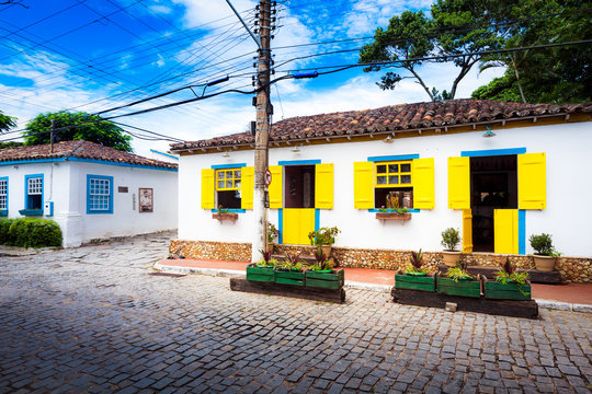 Small white houses with colorful window shutters in Buzios, Braz