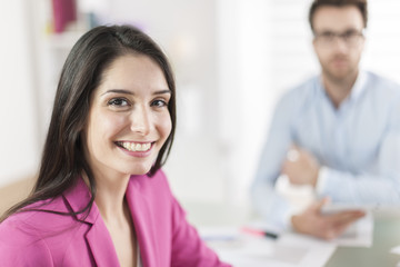 Portrait of a smiling businesswoman in meeting