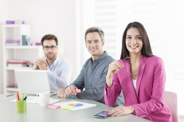 Portrait of a smiling businesswoman in meeting