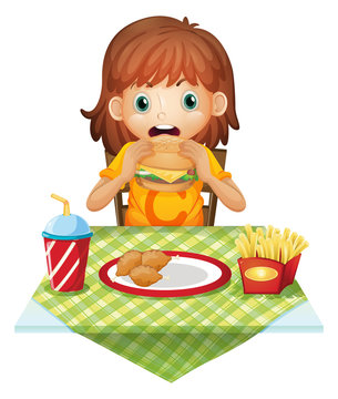 A hungry little girl eating