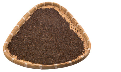 Dried and processed tea leaves in a wicker tray