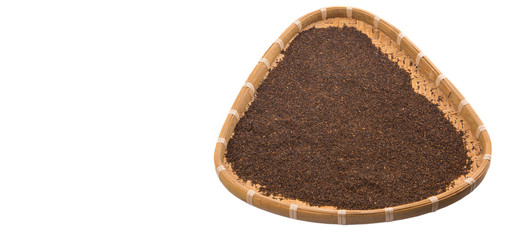 Dried and processed tea leaves in a wicker tray