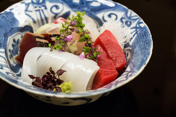 Japanese sashimi plate isolated on black