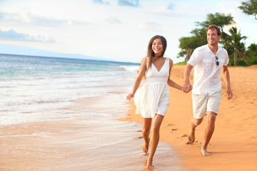 Beach couple on romantic travel honeymoon fun