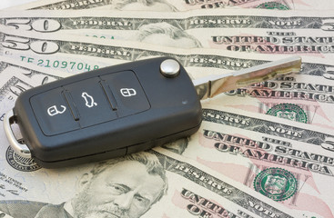 Car keys over dollar banknotes