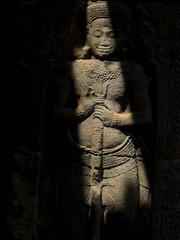 Shadow cast over carved figure at Banteay Kdei, Angkor Wat