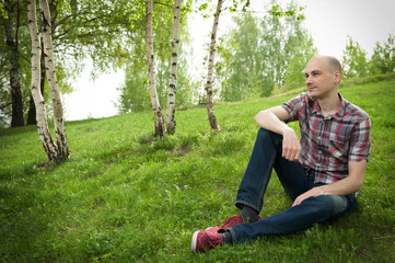 Naklejka na ściany i meble young man relaxing in summer park