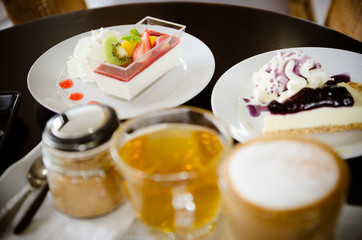 Cappuccino and assorted desserts.