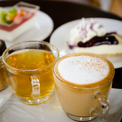 hot cappuccino and hot tea with cakes.
