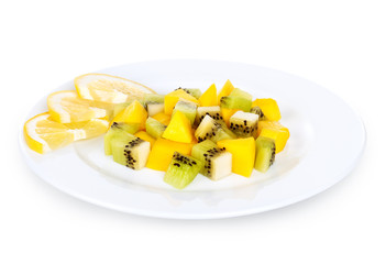 sliced kiwi mango lemons on a plate