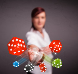 Young woman throwing dices and chips