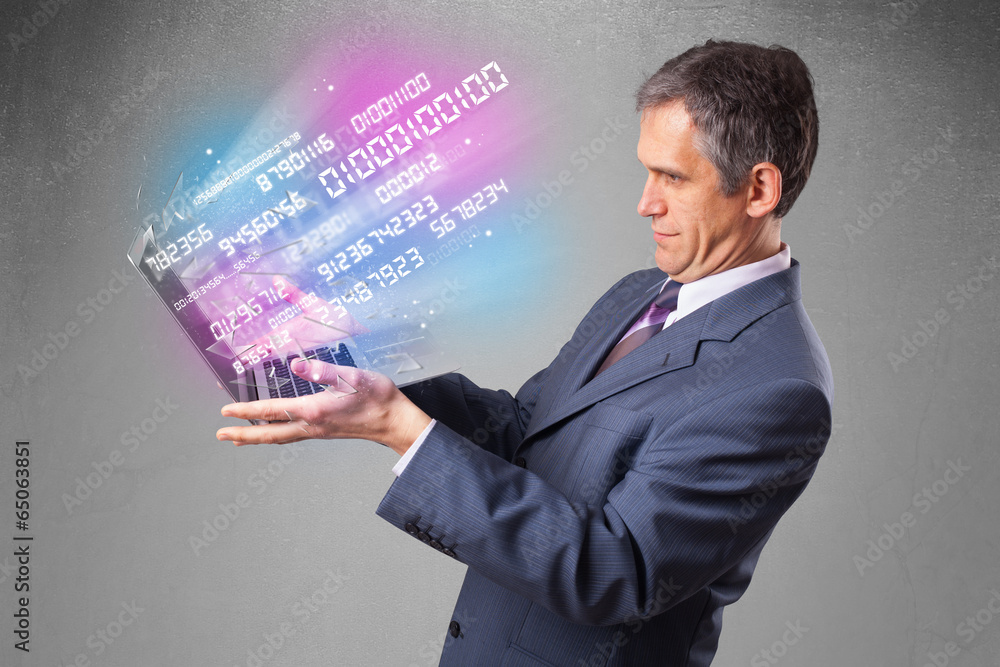 Wall mural Businessman holding notebook with exploding data and numbers