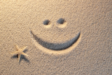 Smile symbol on beach background