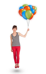 Young woman holding colorful balloons