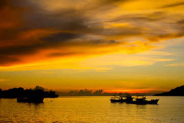 Fototapeta na wymiar Fishing Boat at Sunset on ocean
