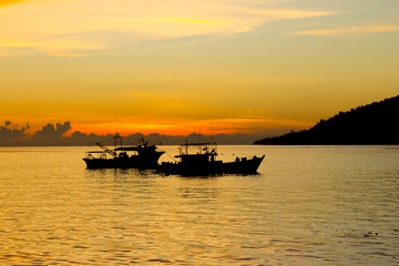 Obraz premium Fishing Boats on sea at sunset