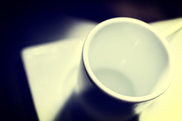 White cup on dark table