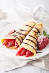 pancakes with strawberry and chocolate sauce