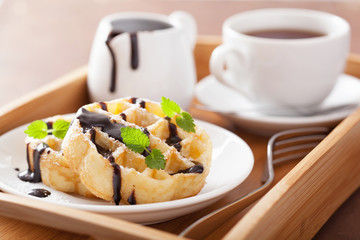 Belgian waffles with chocolate and powder sugar for breakfast