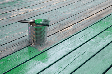 Renovation and painting of a wooden terrace with green wood preservative paint, exterior