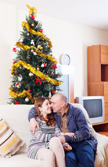 Obraz na płótnie Canvas Happy loving couple near Christmas tree