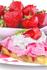 Delicious strawberry cake with ripe fruit in the background