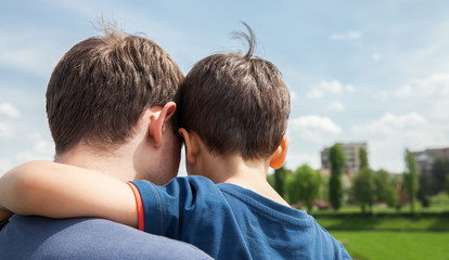 Father and son on a city background