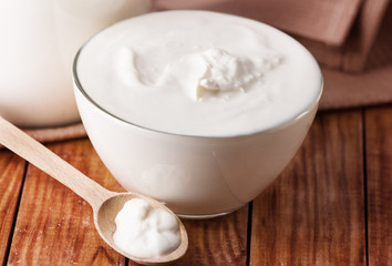 sour cream, yogurt on wooden background