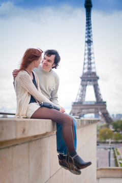Loving couple smiling near the Eiffel Tower in Paris