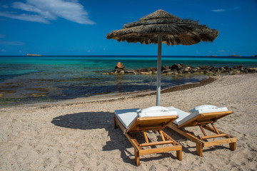 Sea, beach, sunbed, umbrella. Lindos, Rhodes Greek island. Greece