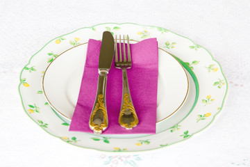 Flatware on a tablecloth.