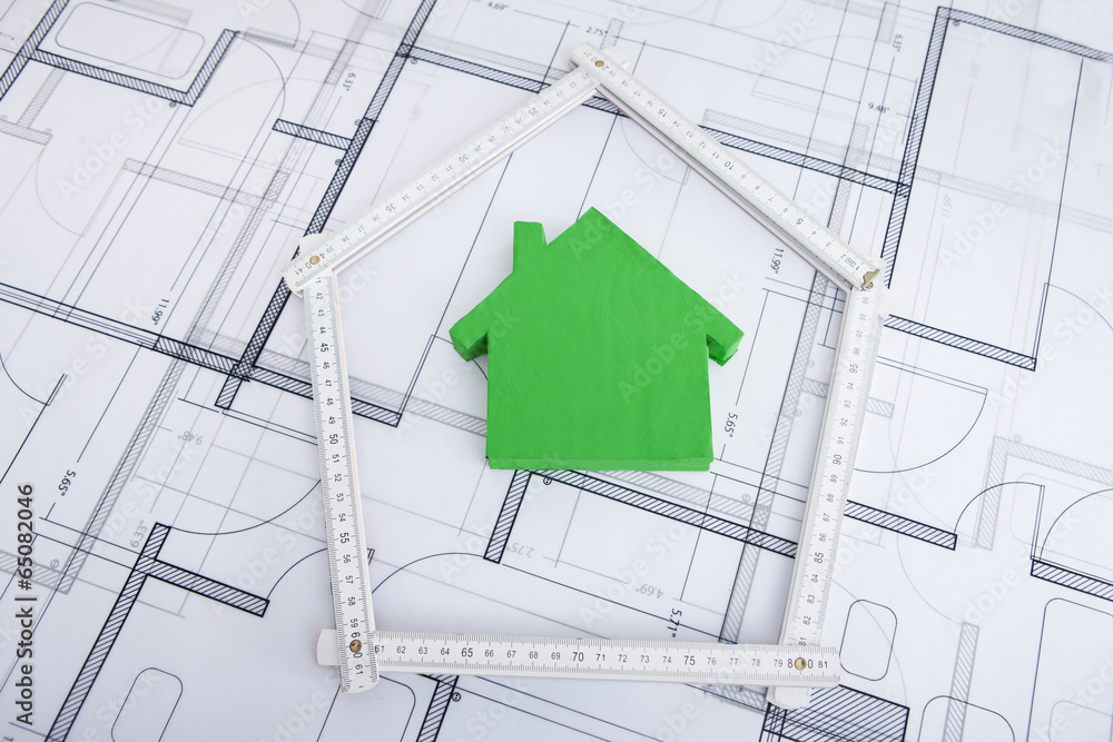 Poster house in folding ruler on blueprint