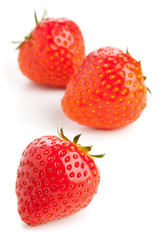 Three strawberries over white background