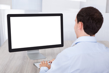 Businessman Using Desktop Pc At Desk