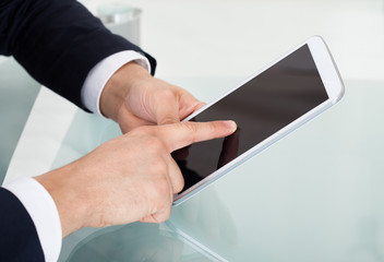 Businessman Using Digital Tablet At Desk