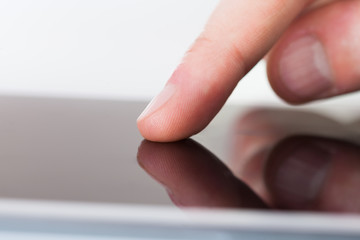 Businessman Touching Digital Tablet's Screen At Desk