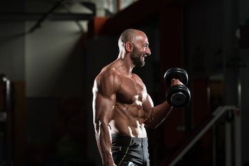 Fototapeta na wymiar Mature Man Doing Exercise For Biceps