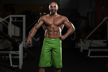 Fototapeta na wymiar Mature Muscular Man Flexing Muscles