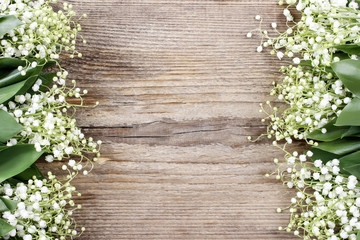 Lily of the valley flowers on wooden background.