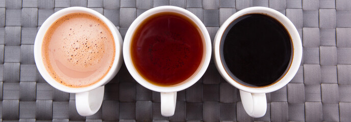 Hot beverages of chocolate, tea and black coffee on woven place  - 65088652